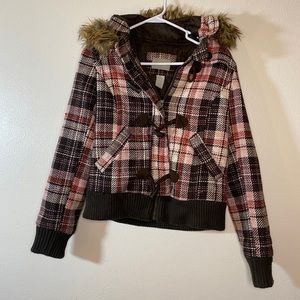 Delia’s flannel jacket with fur around the hood.